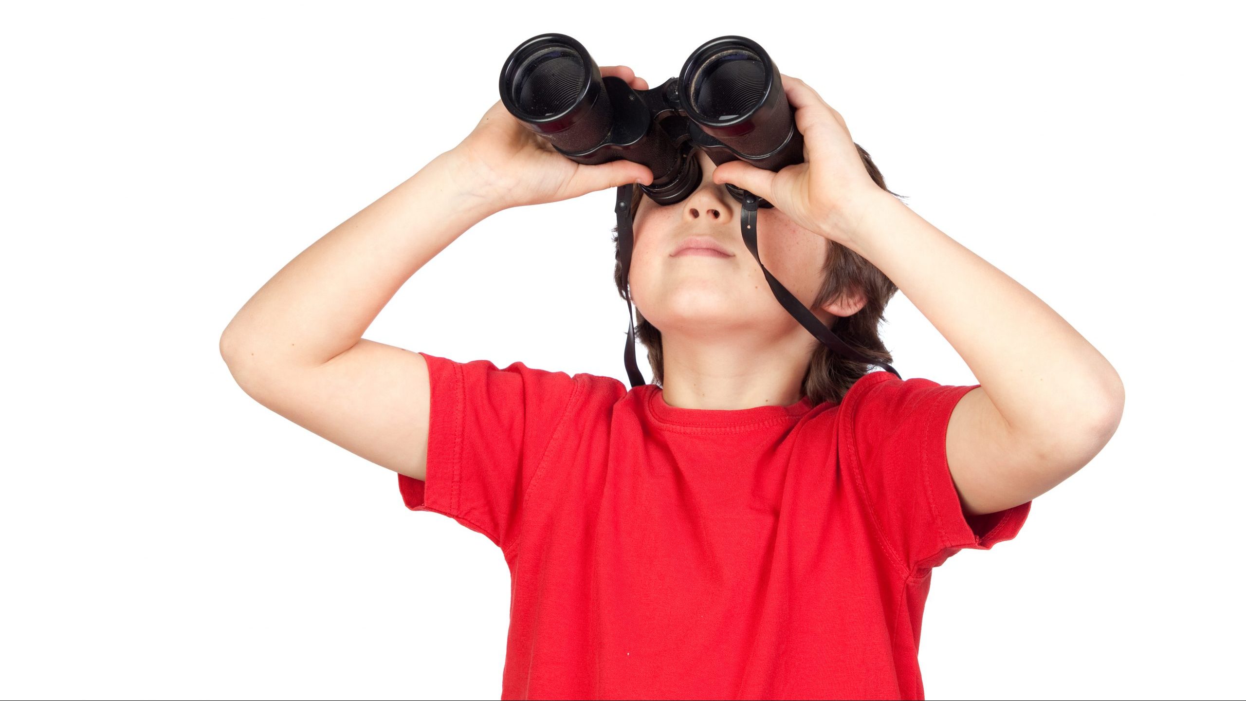 A boy in a red shirt looking through binoculars