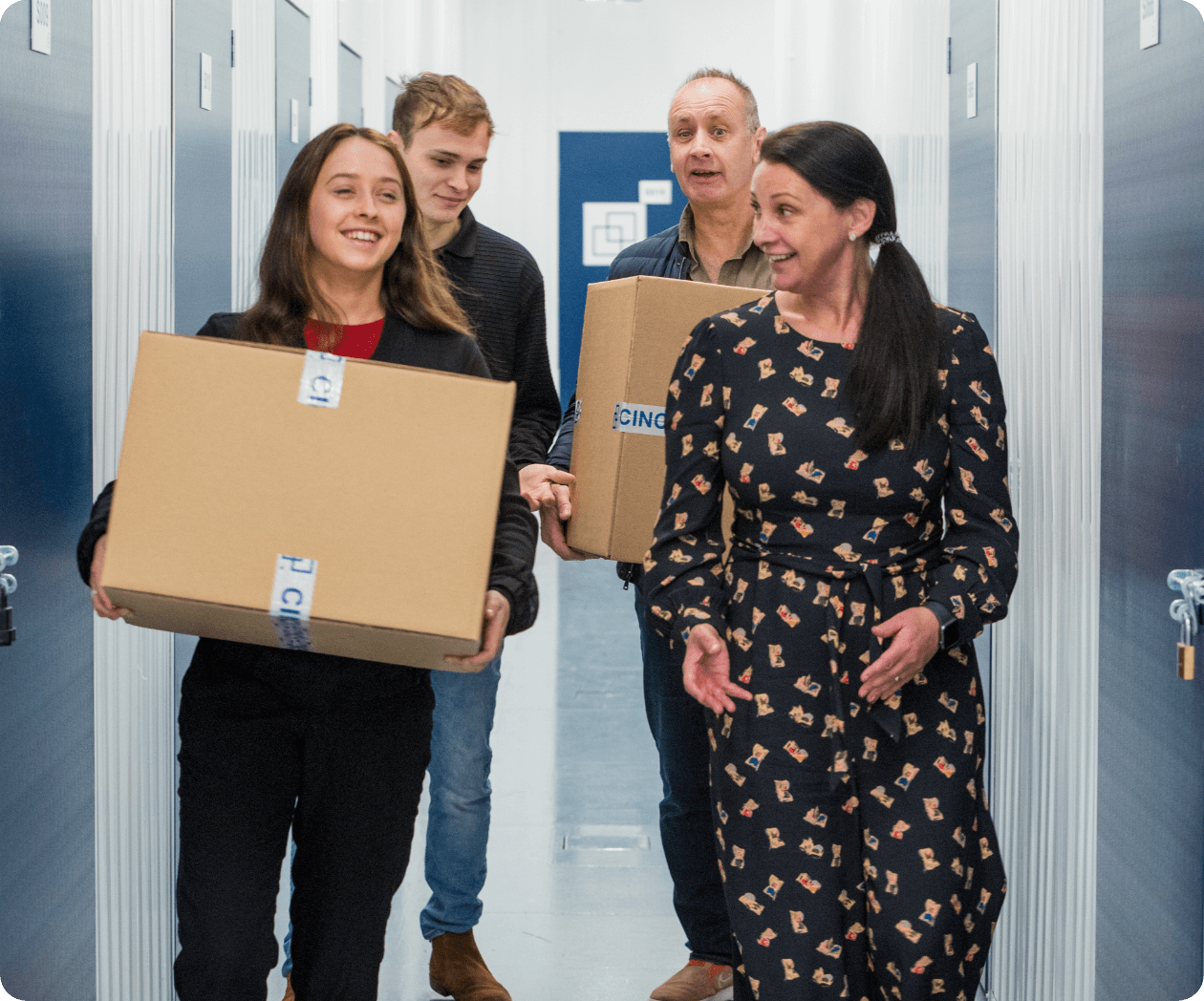 Happy family at walking down corridor at Cinch Self Storage