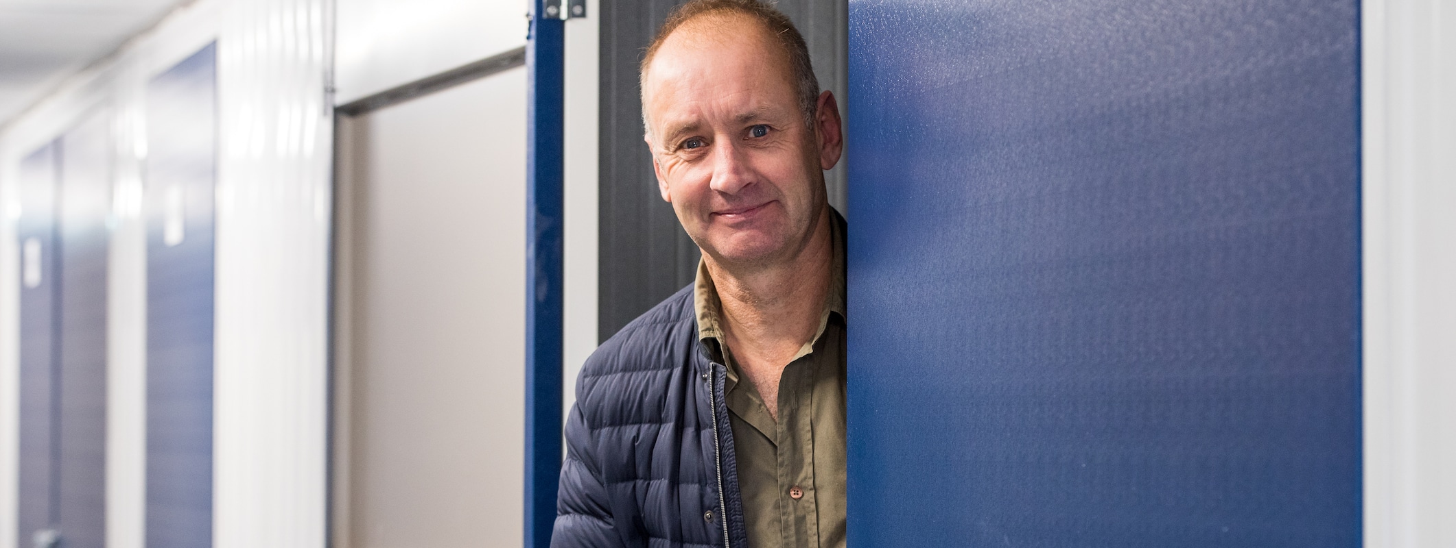 Man standing at entry of storage unit