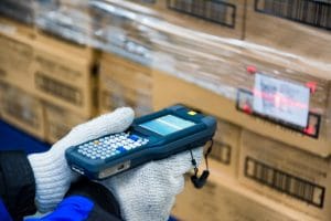 A warehouse worker scanning boxes