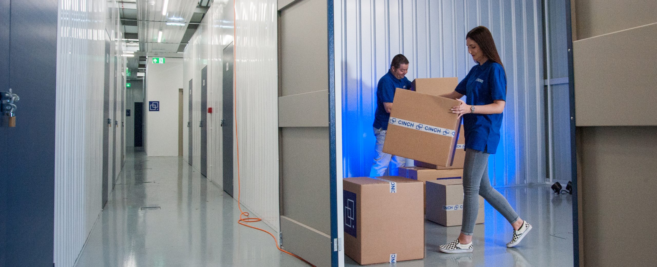 Cinch self storage staff helping customer move in