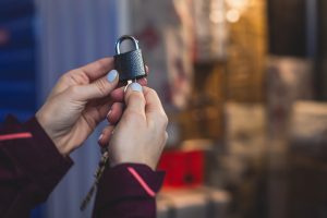 Woman with blue nail polish holding a lock