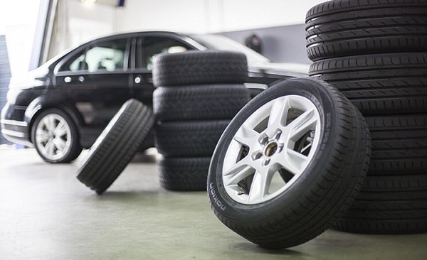 A car and car tyres in a garage