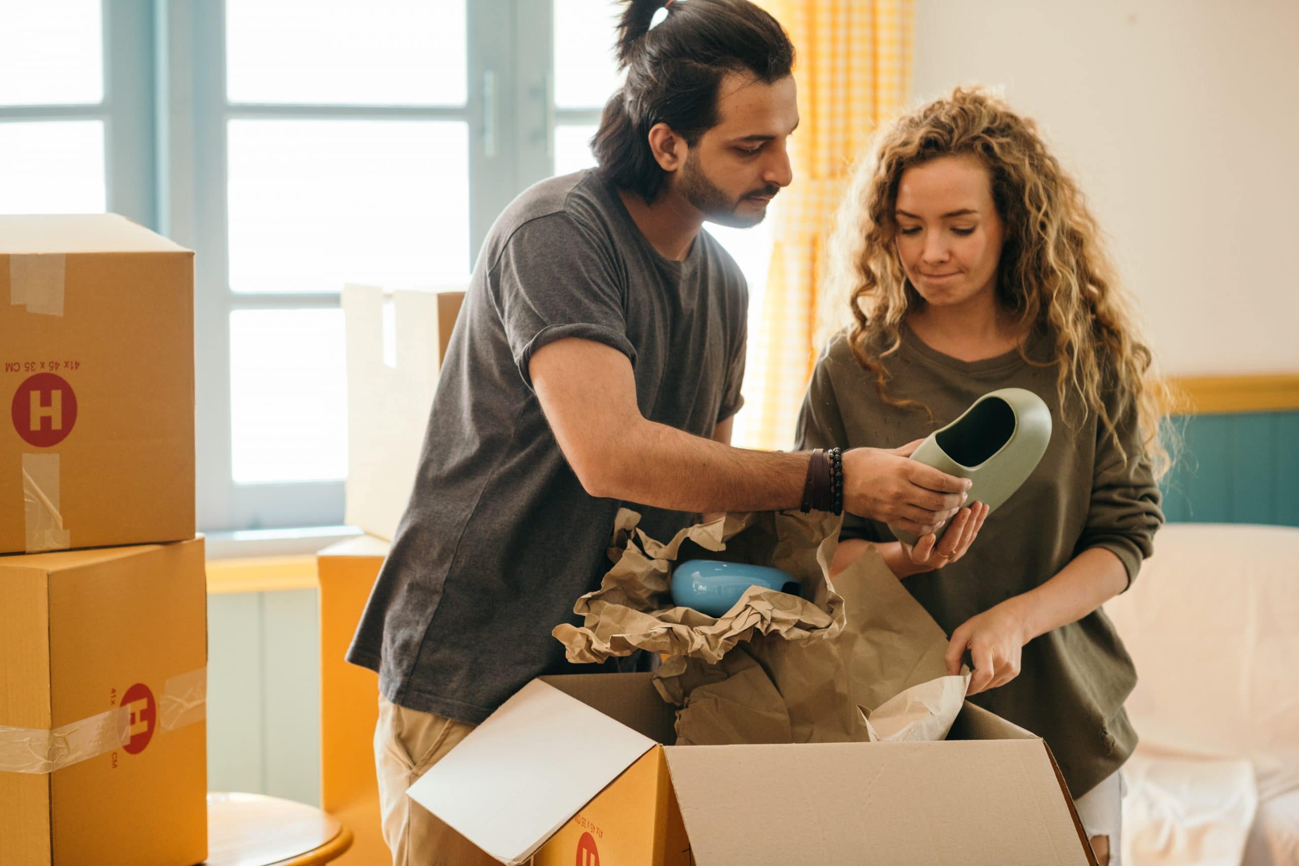 A couple sorting items for a move