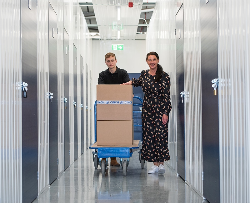 Cinch employee helping customer wheel boxes to storage units Edmonton