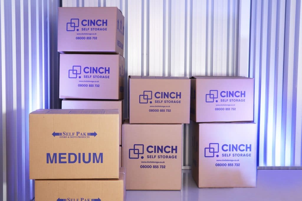 Cinch Self Storage Newbury inside of unit with Cinch Self Storage cardboard boxes stacked on top of each other