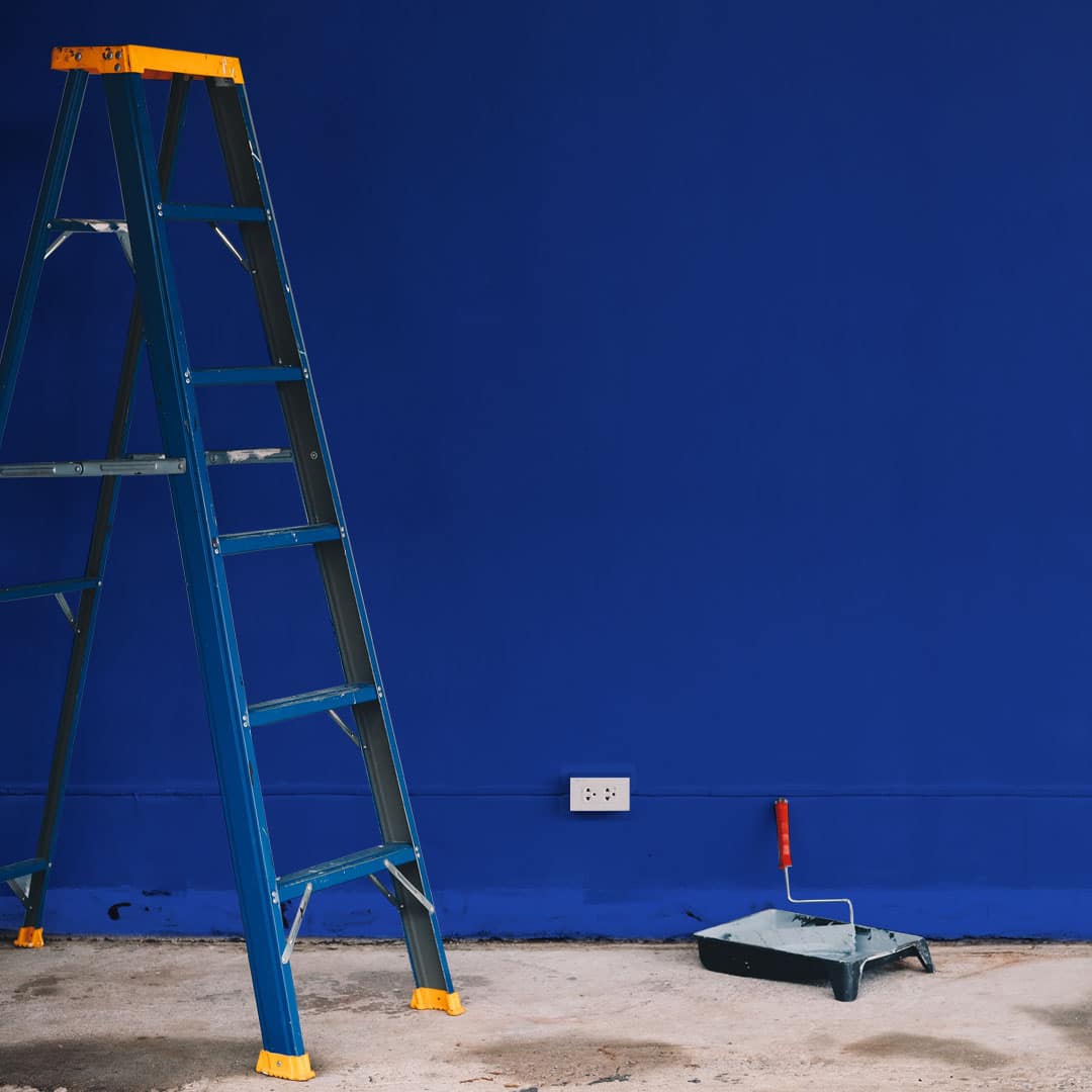 Room being decorated Cinch blue with step ladder and paint roller, unfinished