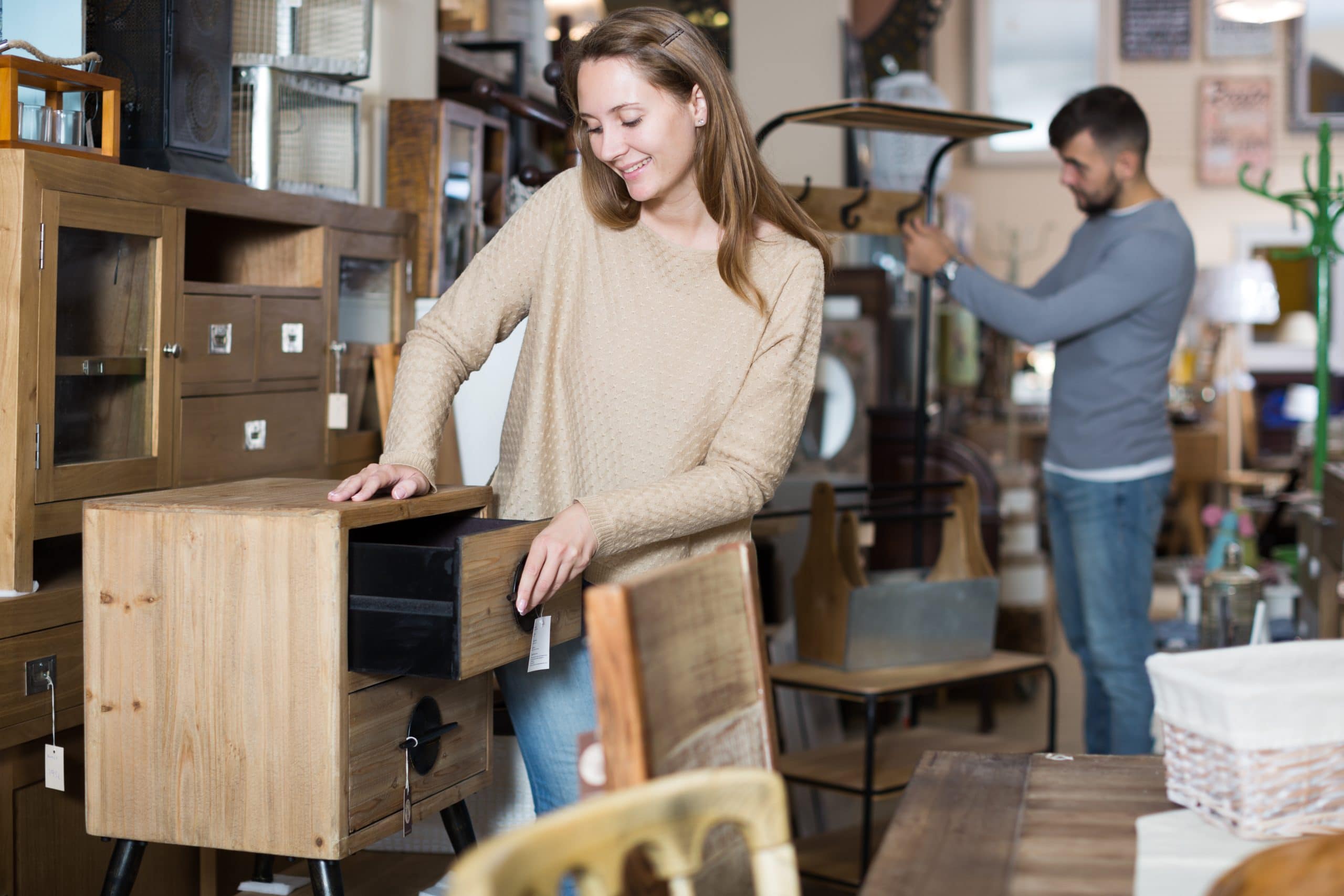 Woman looking at furniture in secondhand Enfield shop