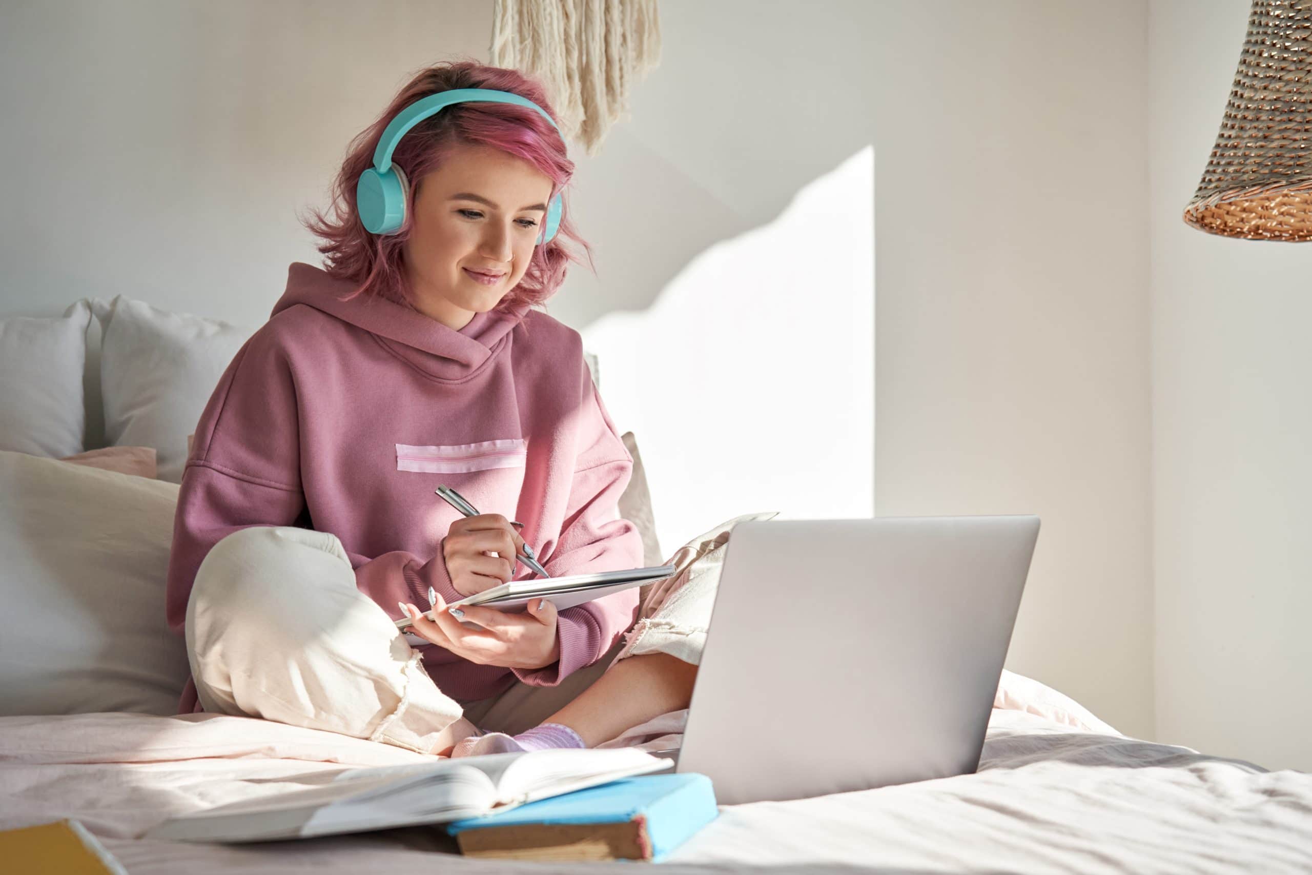 Bicester student sitting on bed in sunlit bedroom 