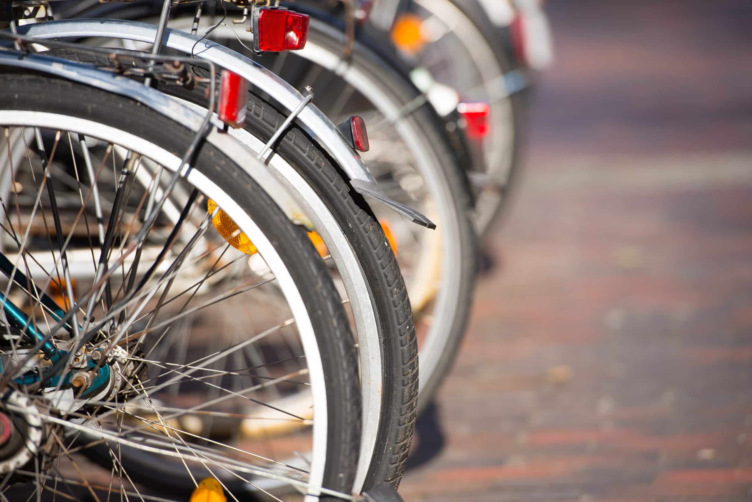 Wheels of bicycles lined up in bike storage Huntingdon