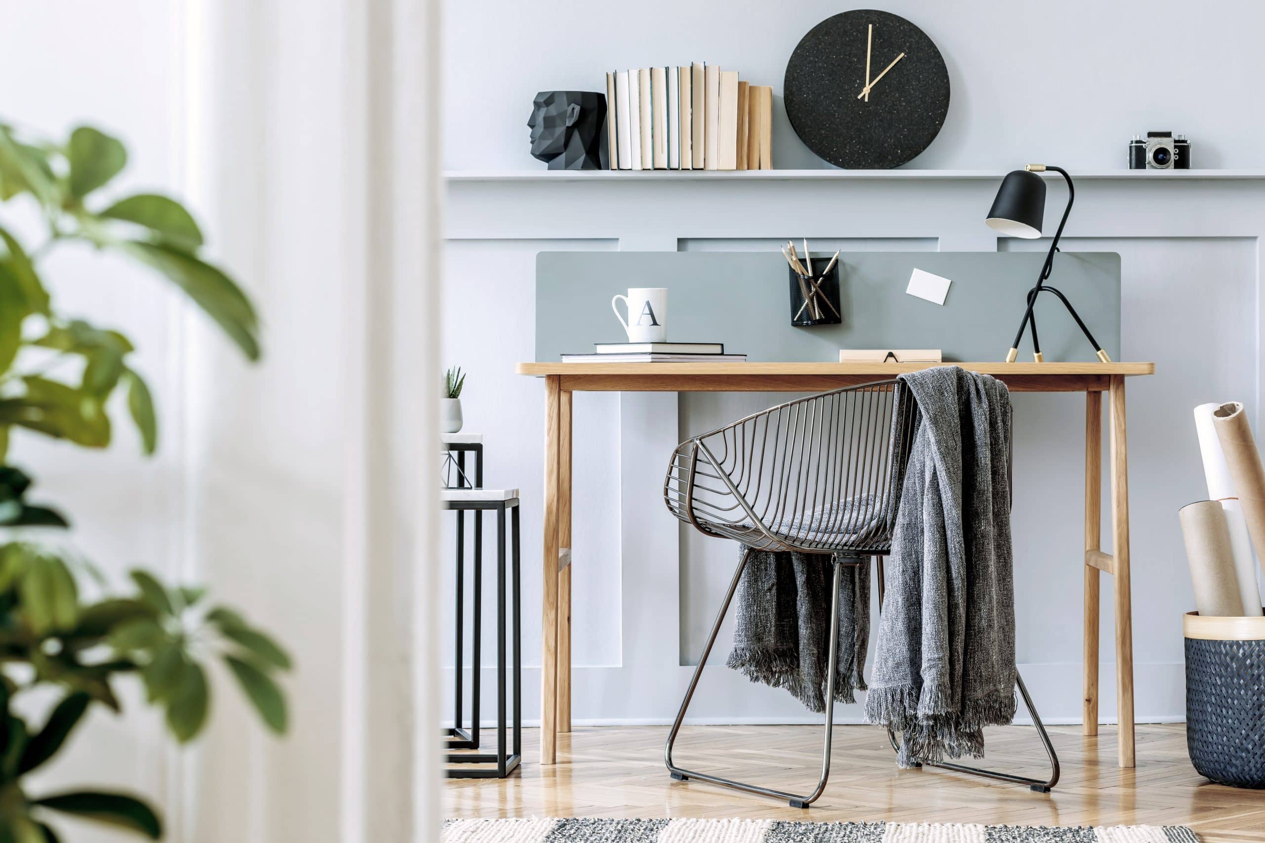 home office staged for a real estate sale with desk, chair and plant