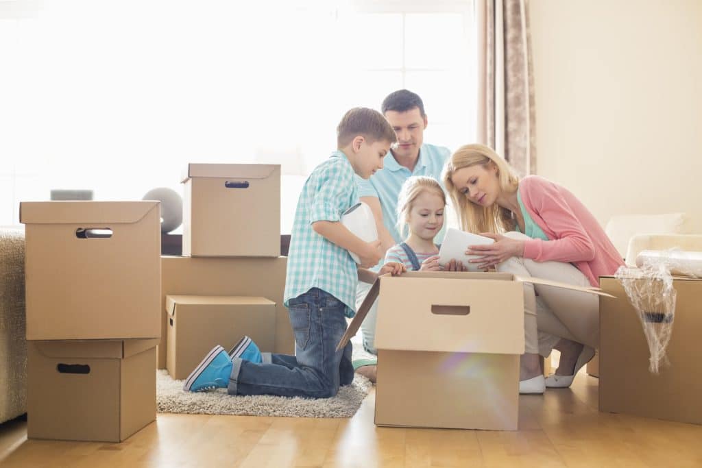 Family packing up boxes to go into storage when moving house