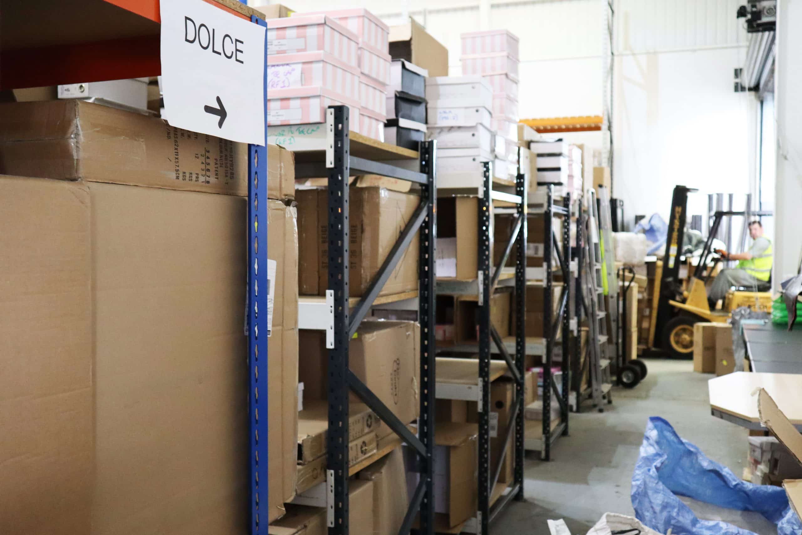 Image showing commercial storage racking with boxes stacked and a forklift truck moving stock around