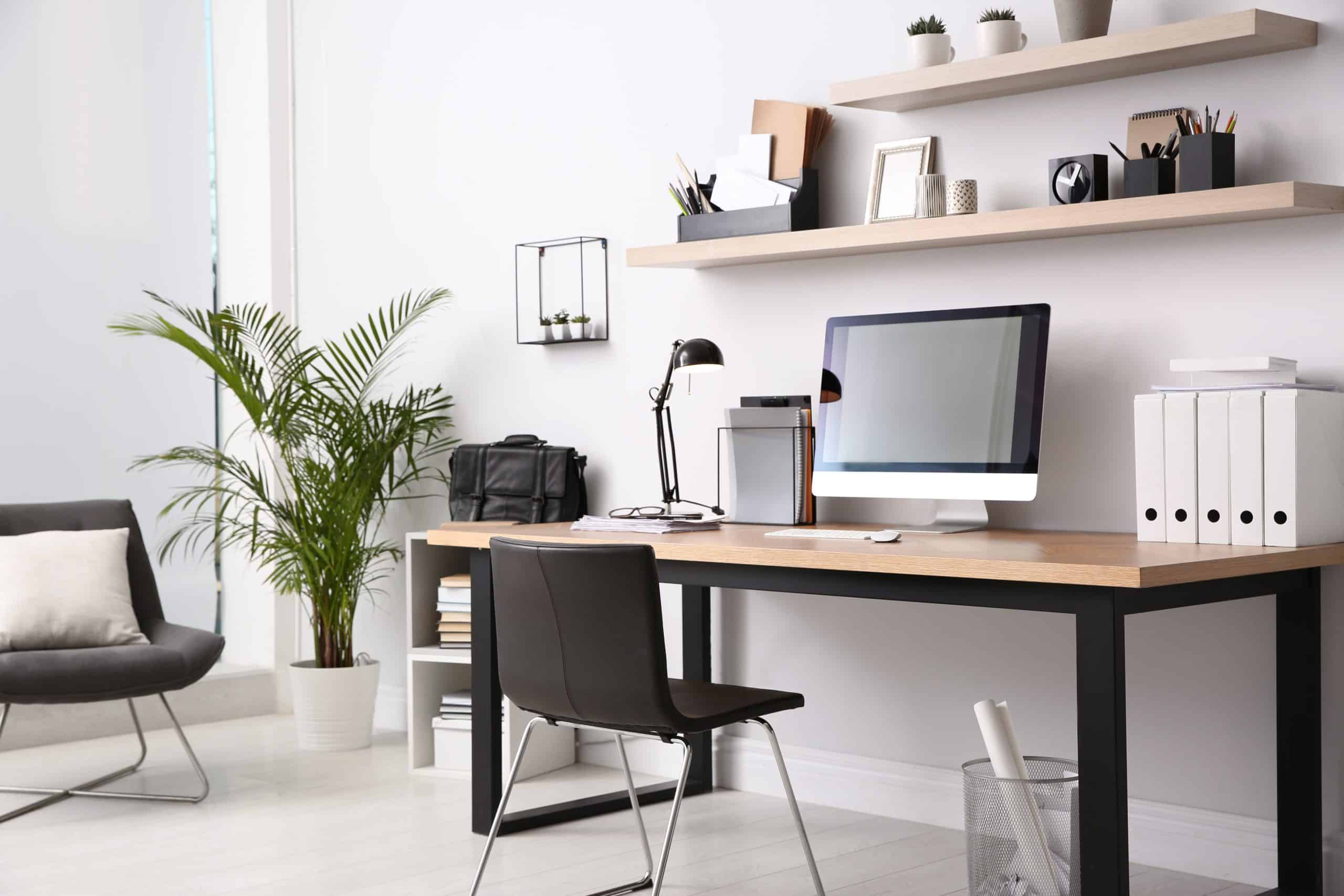 Office space Enfield - interior of office with desk, computer, shelving and plant