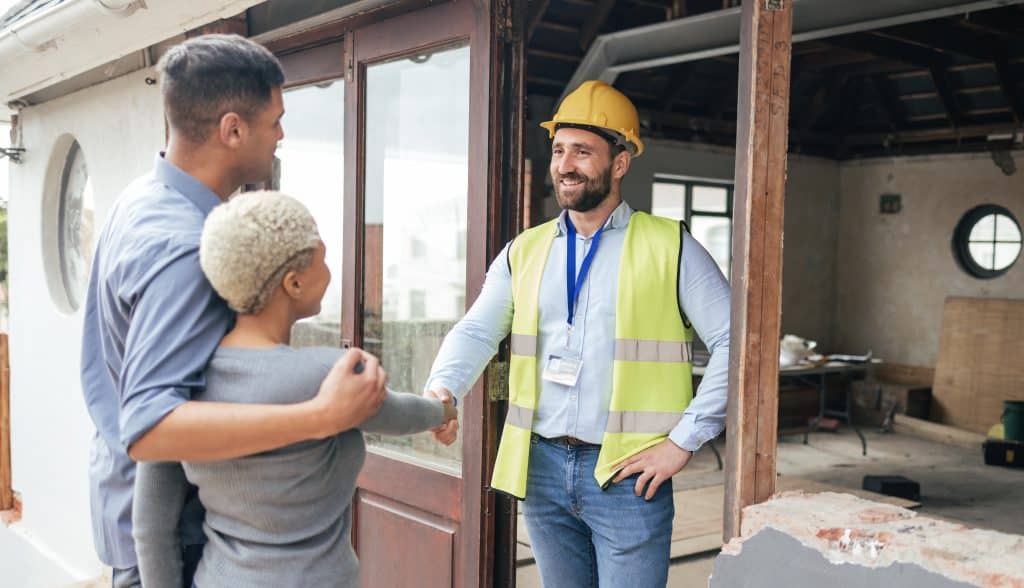 Storage in Enfield - How storage can help with your renovations this year. Image shows home rennovation showing a couple meeting with their builder at their home