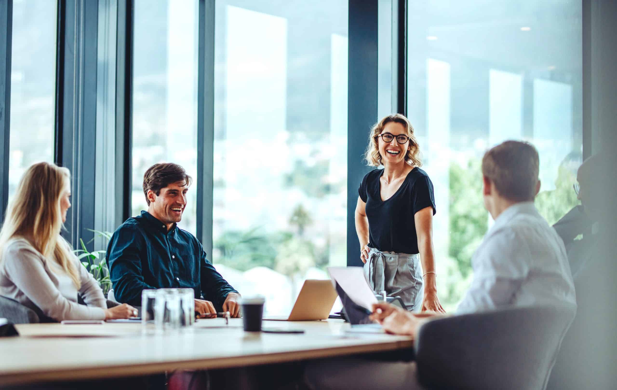 Storage in Newbury - image shows a business group sitting at a table and one woman standing smiling