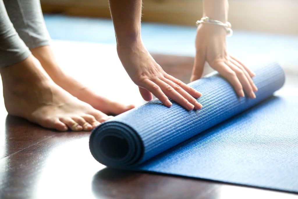 Storage facilities in Hove - image shows a blue yoga mat being rolled out onto the floor 