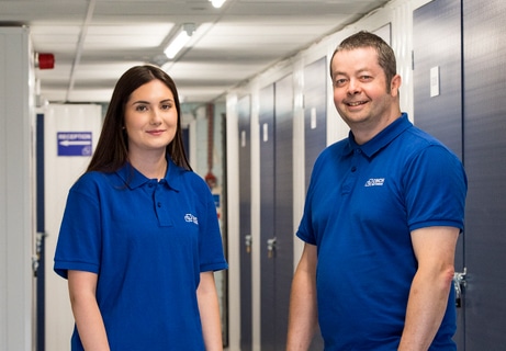 Happy family at walking down corridor at Cinch Self Storage