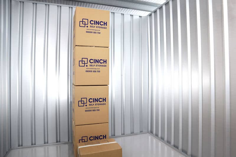 Wimbledon storage. Image shows the interior of a storage unit with a tower of stacked Cinch Self Storage cardboard boxes inside.