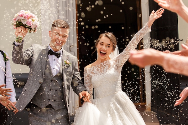 Storage facilities in Brentwood. Image shows happy couple in wedding dress and suit with arms in the air and confetti being thrown. 