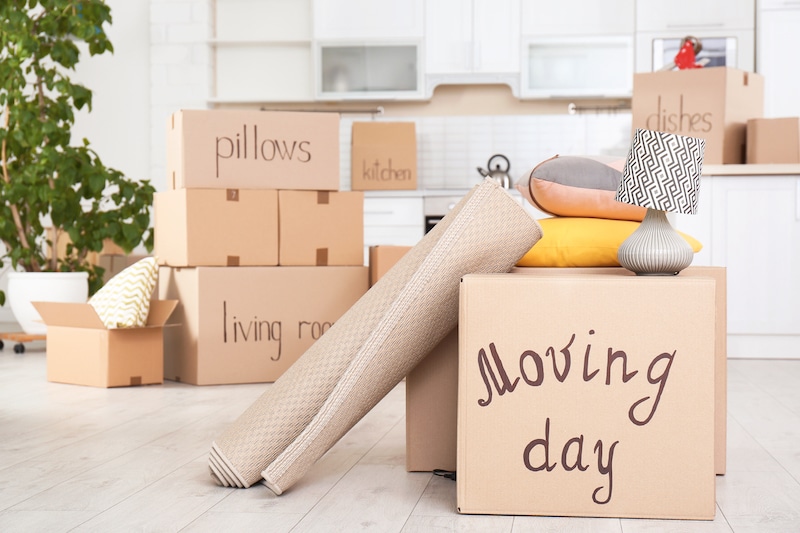 Self storage Seaford. Image shows boxes filled with things ready to move stacked in the kitchen with 'moving day' written on the front box. 