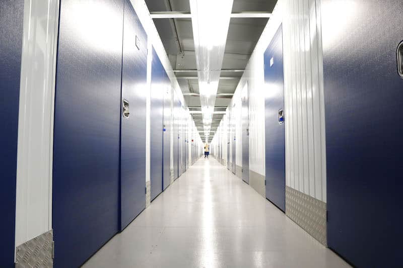 Self storage in Southend. Image shows the corridor of Southend storage facility with blue doors on either side. 