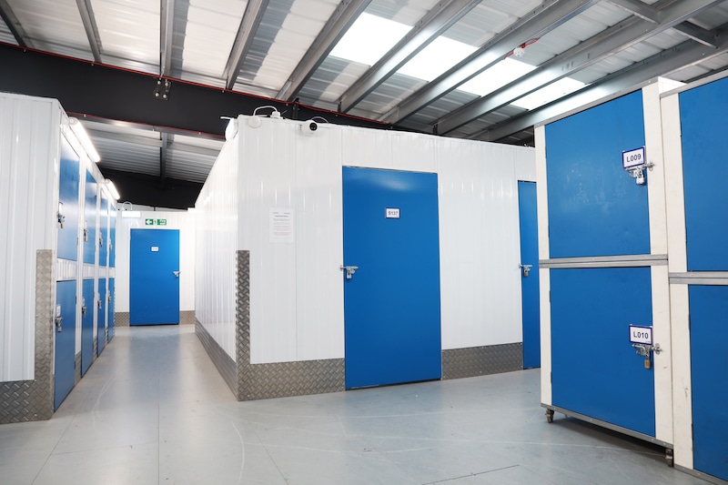 storage_unit_in_Woking. Image shows a hallway with storage units with blue doors.