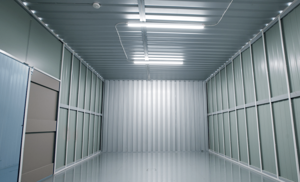 7 benefits of renting an industrial unit for your business. Image shows the inside of a large industrial unit with strip lighting on the ceiling. 