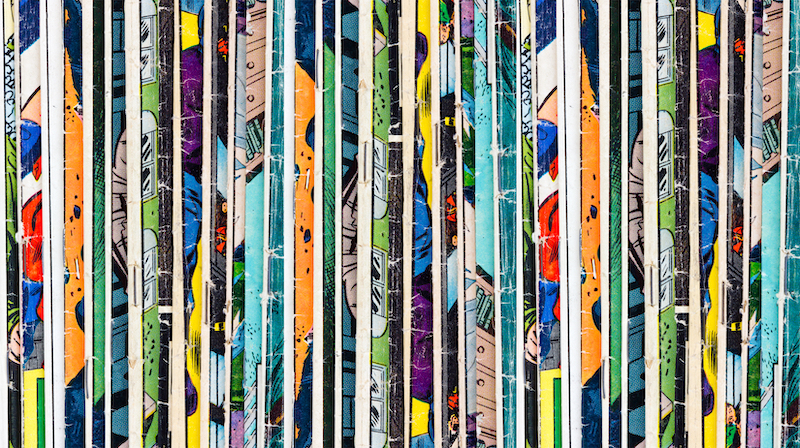 The ultimate guide to comic book storage. Image shows a stack of old vintage comic books background texture