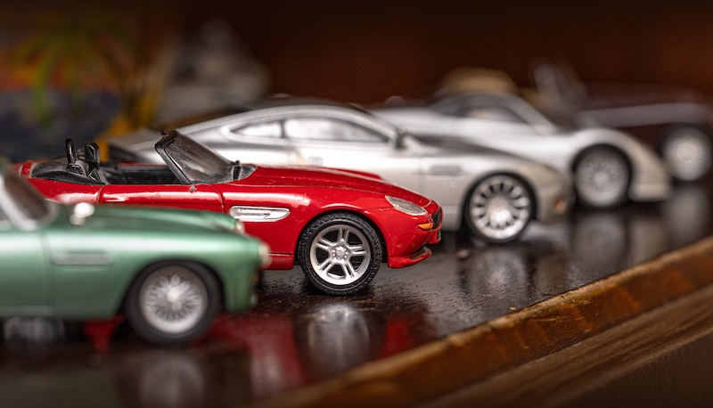 Storage Chippenham UK. Image shows classic model vehicles or toy vehicles. Miniature collection of automobiles. Retro car models on shelf. Retro style cars. Toy cars with retro design.