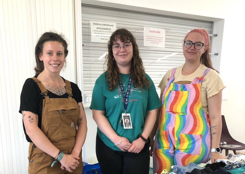 Huntingdon Community Swap. Image shows three people standing in front of storage unit.