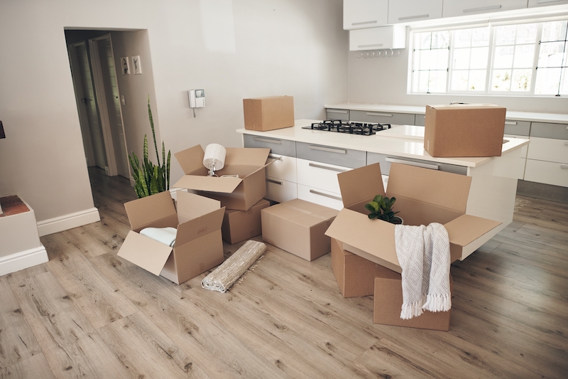 House move storage Woking. Image shows a kitchen with boxes on the floor being packed for moving house.