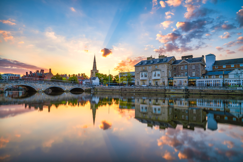 Areas to live in Bedford. Image shows the embankment at sunset in Bedford.