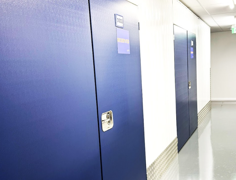 London student storage. Image shows a view of a self storage corridor with blue doors.
