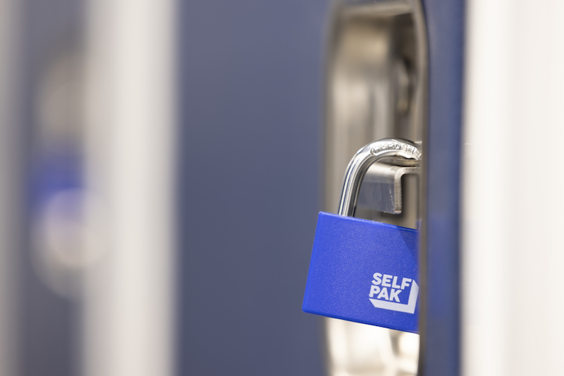 Storage units Wisbech. Image shows a close up view of a blue padlock on a blue storage unit door.