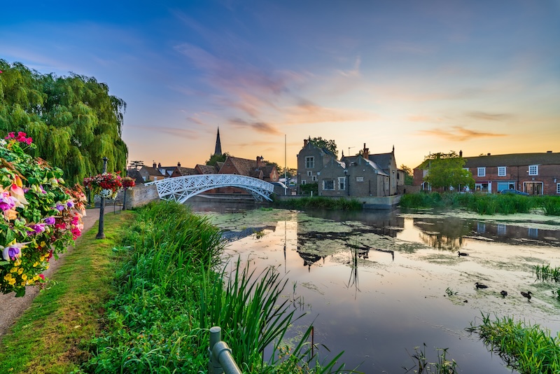 Is Huntingdon a nice place to live. Image shows Chinese Bridge at sunrise in Godmanchester Cambridgeshire England